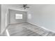 Bright bedroom with wood-look floors and ceiling fan at 2140 Upland Ave, Pahrump, NV 89048