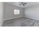 Bright bedroom with ceiling fan, window, and grey laminate flooring at 2140 Upland Ave, Pahrump, NV 89048