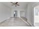 Bright, airy bedroom featuring wood floors, ceiling fan, and doors leading to the backyard at 2140 Upland Ave, Pahrump, NV 89048