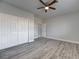 Spacious bedroom featuring wood floors, a ceiling fan, and a closet at 2140 Upland Ave, Pahrump, NV 89048
