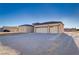 Contemporary home featuring a large garage, neutral tones, and modern lighting fixtures for a welcoming facade at 2140 Upland Ave, Pahrump, NV 89048