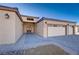 Front entry of home with two-car garage and walkway at 2140 Upland Ave, Pahrump, NV 89048