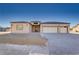 Welcoming home showcasing a three-car garage, modern design elements, and desert-friendly landscaping for curb appeal at 2140 Upland Ave, Pahrump, NV 89048