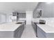 Open kitchen featuring a large center island, stainless steel appliances, and elegant gray cabinetry at 2140 Upland Ave, Pahrump, NV 89048