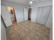 Bedroom with tile floors, adjacent bathroom, and mirrored closet at 2208 W Washington Ave, Las Vegas, NV 89106
