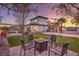Outdoor entertaining area with fire pit, putting green, and seating at 282 E Maulding Ave, Las Vegas, NV 89123