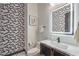 Small bathroom with a sink, toilet, and geometric wallpaper at 282 E Maulding Ave, Las Vegas, NV 89123