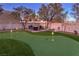 Landscaped backyard with putting green and fire pit at 282 E Maulding Ave, Las Vegas, NV 89123