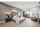 Spacious bedroom with light wood floors and large window at 2824 Queens Courtyard Dr, Las Vegas, NV 89109