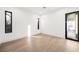Bright bedroom with wood floors and access to a private balcony at 2824 Queens Courtyard Dr, Las Vegas, NV 89109