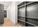 Spacious walk-in closet with gray shelves and hanging space at 2824 Queens Courtyard Dr, Las Vegas, NV 89109