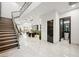 Elegant entryway with modern staircase and powder room at 2824 Queens Courtyard Dr, Las Vegas, NV 89109