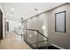 Modern hallway with light wood floors and metal railing at 2824 Queens Courtyard Dr, Las Vegas, NV 89109