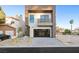 Modern home exterior with attached garage and landscaping at 2824 Queens Courtyard Dr, Las Vegas, NV 89109