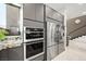 Sleek kitchen featuring double ovens and a stainless steel refrigerator at 2824 Queens Courtyard Dr, Las Vegas, NV 89109