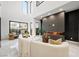 Spacious living room with high ceilings, fireplace, and large windows at 2824 Queens Courtyard Dr, Las Vegas, NV 89109