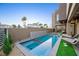 Modern pool and spa with stone accents and artificial turf at 2824 Queens Courtyard Dr, Las Vegas, NV 89109