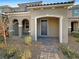 Two-story home with arched entryway and well-manicured landscaping at 3206 Brynley Ave, Henderson, NV 89044