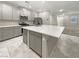 Modern kitchen with large island, stainless steel appliances, and gray cabinets at 3206 Brynley Ave, Henderson, NV 89044