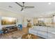 Open concept living area with large TV and view into the kitchen at 335 Alto Avec Ln, Henderson, NV 89011