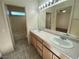 Bathroom boasts double sinks, lighted vanity mirror, and a tub at 4355 Sunrise Shores Ave, North Las Vegas, NV 89031