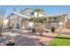 Two-story house with gray siding, landscaped yard, and a two-car garage at 5240 Chela Dr, Las Vegas, NV 89120