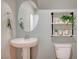 Modern powder room with pedestal sink and floating shelves at 639 Morbucks Ln # 1044, Henderson, NV 89011