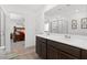 Double vanity bathroom with a large mirror and shower at 6823 Camino Real St, North Las Vegas, NV 89086