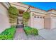 Front entry with wrought iron gate and landscaped walkway at 7096 Wild Wave Dr, Las Vegas, NV 89131