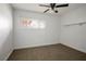 This cozy bedroom features a ceiling fan, a window and neutral carpeting at 71 E Atlantic Ave, Henderson, NV 89015