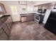 Galley kitchen with dark brown cabinets and tile floors at 71 E Atlantic Ave, Henderson, NV 89015