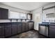 Updated kitchen featuring dark cabinets, stainless steel appliances and stained glass door at 71 E Atlantic Ave, Henderson, NV 89015