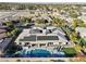 Stunning aerial view of the home with a refreshing backyard pool and spa, enhanced by solar panels at 8075 Palm Cove Ct, Las Vegas, NV 89129