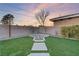 Landscaped backyard with fire pit and artificial turf at 8075 Palm Cove Ct, Las Vegas, NV 89129