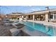 Inviting backyard oasis featuring a sparkling pool, fire pits, and lounge chairs at 8075 Palm Cove Ct, Las Vegas, NV 89129