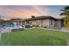 Expansive backyard featuring a sparkling pool, spa, and manicured lawn at 8075 Palm Cove Ct, Las Vegas, NV 89129