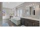 Luxurious primary bathroom featuring a soaking tub, double vanities, and modern fixtures for relaxation at 8075 Palm Cove Ct, Las Vegas, NV 89129