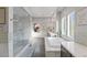 Bright bathroom features a glass enclosed shower, soaking tub, and double sink vanity at 8075 Palm Cove Ct, Las Vegas, NV 89129