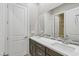 Bathroom featuring double sinks, modern cabinetry, decorative backsplash, and a separate toilet room at 8075 Palm Cove Ct, Las Vegas, NV 89129