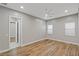 Bright bedroom with wood-look floors and access to another room at 8075 Palm Cove Ct, Las Vegas, NV 89129