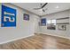 Bedroom with modern ceiling fan, wood floors, natural light, and sports memorabilia at 8075 Palm Cove Ct, Las Vegas, NV 89129