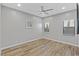 Simple bedroom with wood floors and two windows at 8075 Palm Cove Ct, Las Vegas, NV 89129