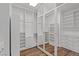Bright walk-in closet with mirrored doors and custom shelving and drawers at 8075 Palm Cove Ct, Las Vegas, NV 89129