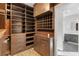Large walk-in closet features custom shelving, drawers, and storage cabinets at 8075 Palm Cove Ct, Las Vegas, NV 89129