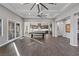 Open concept great room includes a pool table and access to the backyard at 8075 Palm Cove Ct, Las Vegas, NV 89129