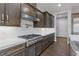 Modern kitchen with dark cabinetry and gas cooktop at 8075 Palm Cove Ct, Las Vegas, NV 89129