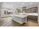 Modern kitchen with a center island, dark wood cabinets, and quartz countertops at 8075 Palm Cove Ct, Las Vegas, NV 89129