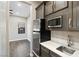 Kitchenette features stainless steel appliances, white countertops and dark cabinets at 8075 Palm Cove Ct, Las Vegas, NV 89129