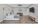 Main bedroom with sitting area, hardwood floors, and a large TV at 8075 Palm Cove Ct, Las Vegas, NV 89129