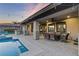 Relaxing covered patio with dining area and BBQ, next to the shimmering pool at 8075 Palm Cove Ct, Las Vegas, NV 89129
